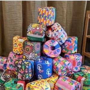 Colourful patterned wrapped rolls stacked in a pyramid